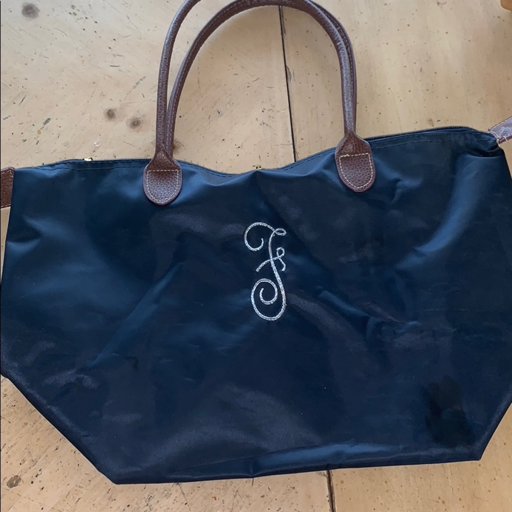 F embroidered navy pocketbook